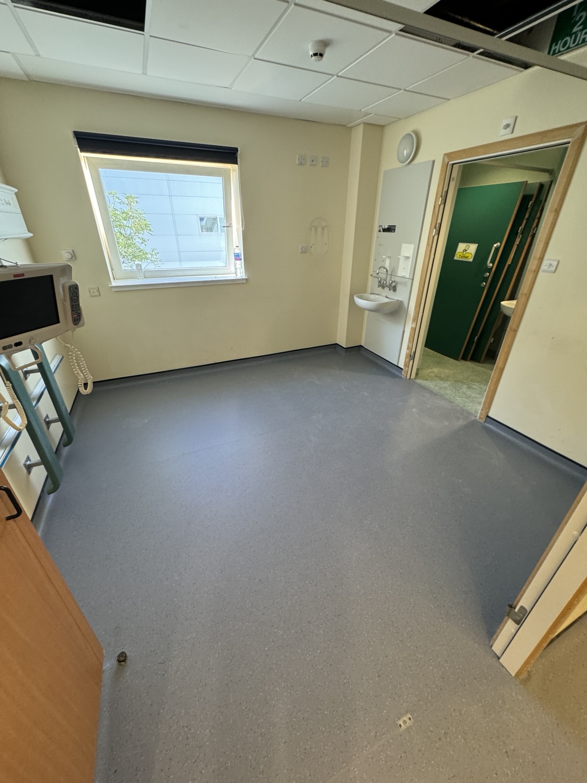 Cap-and-coved Altro safety flooring installed in a hospital patient room