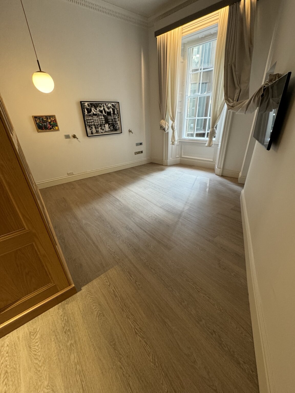 Karndean wood-effect LVT fitted around hotel bedroom joinery