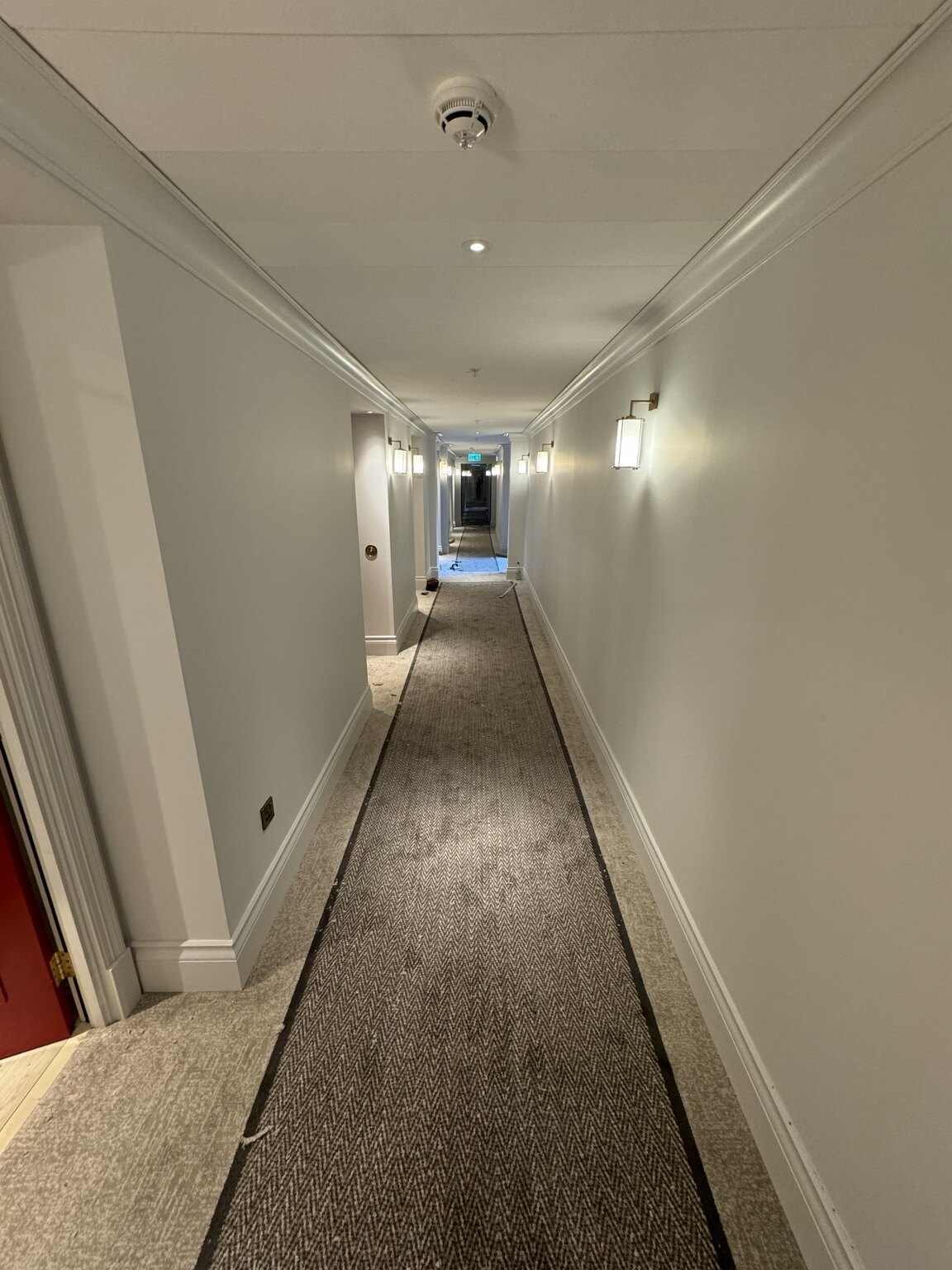 Finished border-designed carpet in a Virgin Hotel hallway